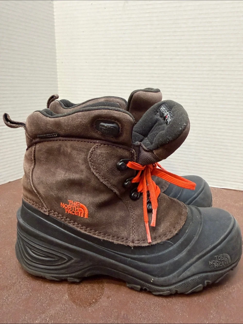 The North Face Kids Brown and Black Winter Boots with Orange Laces